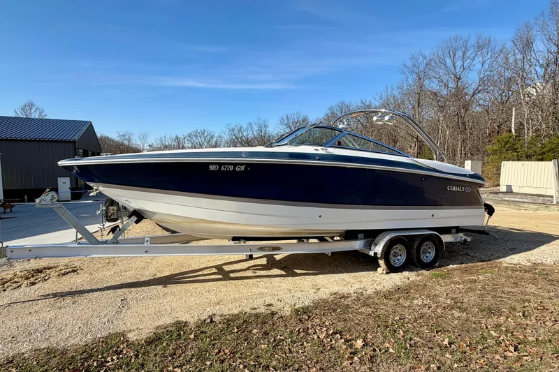 The Image of 2008 Cobalt 282 boat on trailer, parked outdoors on a sunny day. - 0