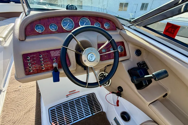 Slide: The Image of 2008 Cobalt 282 boat interior with white leather seating and cup holders. - 11