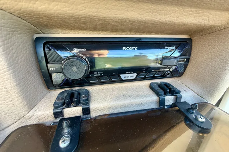 Slide: The Image of Interior of a 2008 Cobalt 282 boat, featuring steering wheel and beige seating. - 16