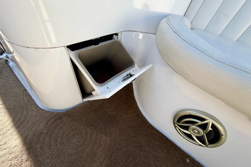 Slide: The Image of 2008 Cobalt 282 boat interior with white leather seating and cup holders. - 23