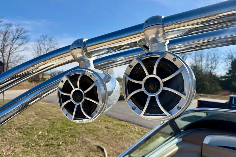 Slide: The Image of Polished speakers on 2008 Cobalt 282 boat, mounted on chrome tubing, under clear blue sky. - 29