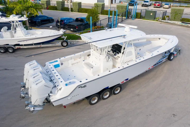 Slide: The Image of Aerial view of 2025 SeaVee 400Z boat with four engines, docked on sandy surface. - 8