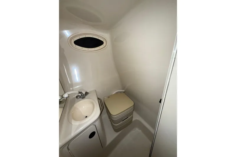 Slide: The Image of Interior cabin of 2000 Sea Ray 240 Sundancer with patterned bedding. - 10