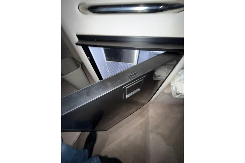 Slide: The Image of Compact bathroom in 2000 Sea Ray 240 Sundancer boat with sink and toilet. - 12