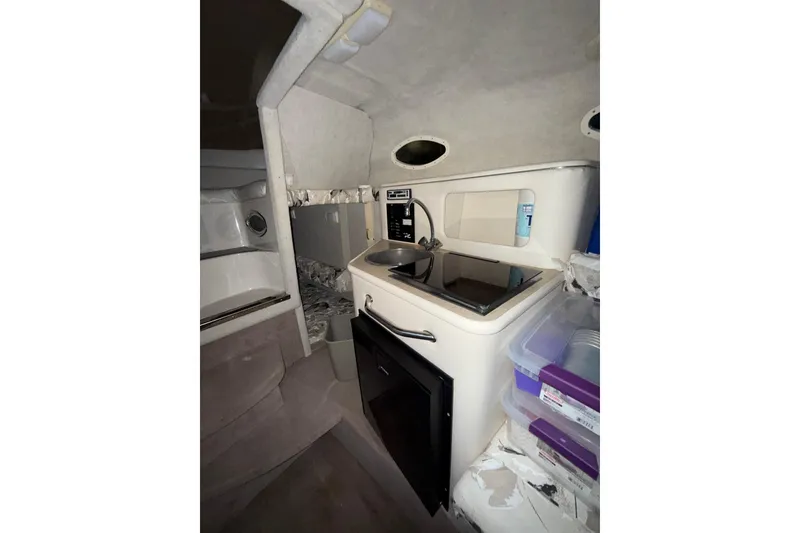 Slide: The Image of Open refrigerator door inside 2000 Sea Ray 240 Sundancer boat cabin. - 14