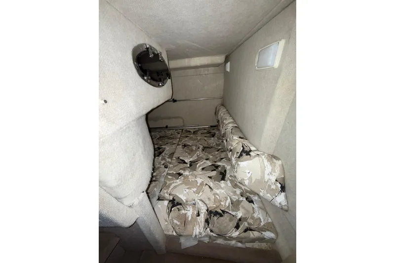 Slide: The Image of Storage compartment inside a 2000 Sea Ray 240 Sundancer boat, showing wiring and a plastic bag. - 18