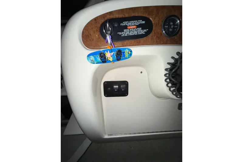 Slide: The Image of Interior cabin of 2000 Sea Ray 240 Sundancer with patterned upholstery and compact design. - 19