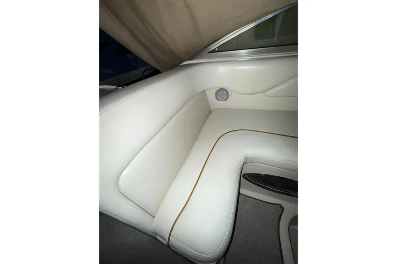 Slide: The Image of Storage compartment on a 2000 Sea Ray 240 Sundancer boat with various items inside. - 24