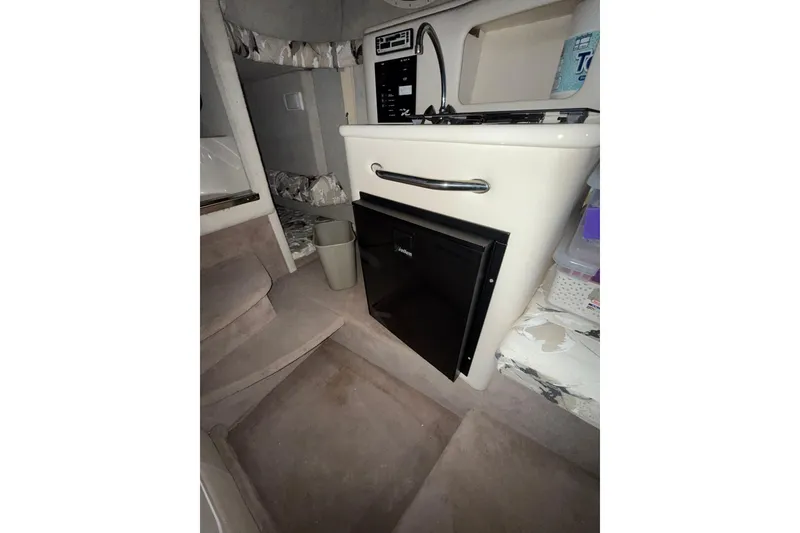 Slide: The Image of 2000 Sea Ray 240 Sundancer boat detail with railing and spotlight in storage. - 9