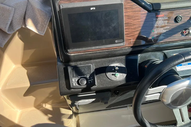 Slide: The Image of Control panel of a 2018 Sea Ray Sundancer 280 boat with steering wheel and navigation display. - 15