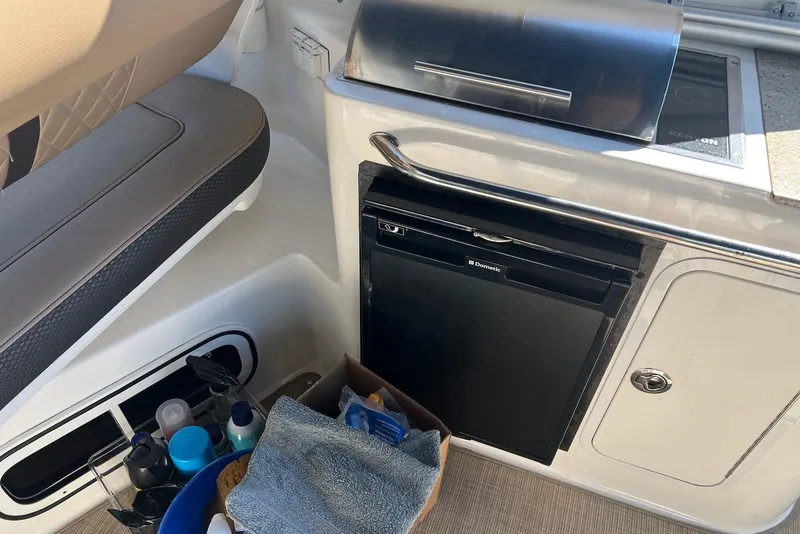 Slide: The Image of Interior of 2018 Sea Ray Sundancer 280 with kitchenette and storage area. - 17
