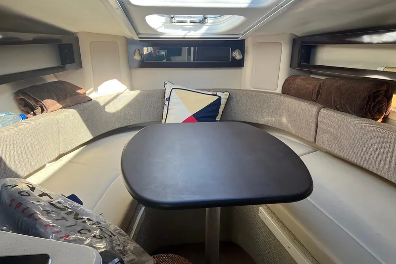 Slide: The Image of 2018 Sea Ray Sundancer 280 cabin interior with seating and table. - 19