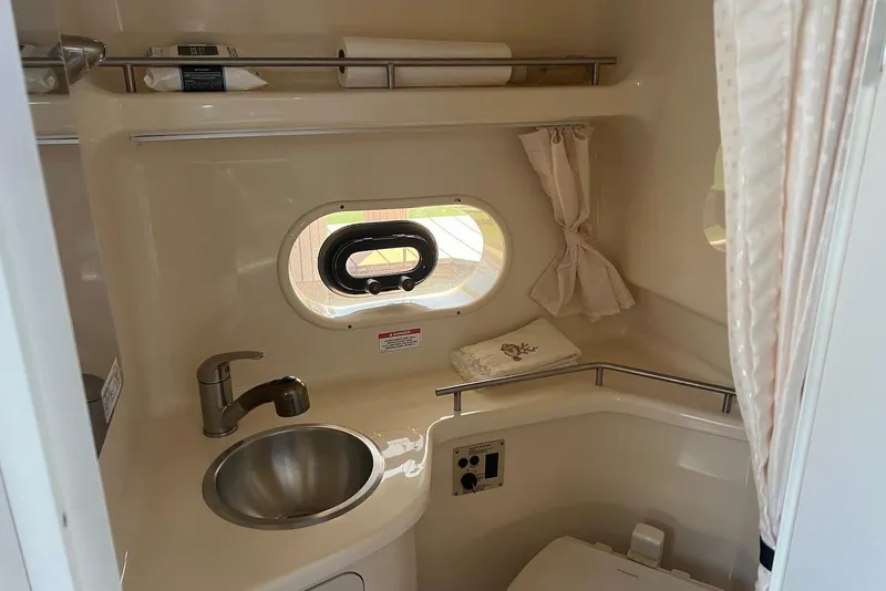 Slide: The Image of 2018 Sea Ray Sundancer 280 bathroom with sink, porthole, and towel rack. - 20