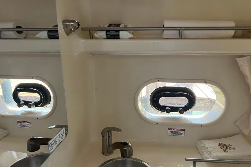 Slide: The Image of Interior of 2018 Sea Ray Sundancer 280 bathroom with sink and porthole window. - 22