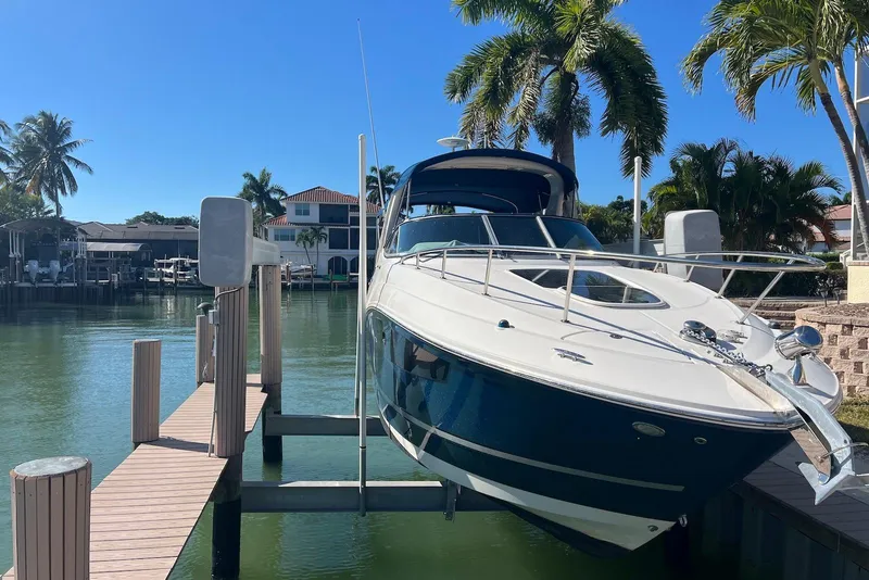 Slide: The Image of 2018 Sea Ray Sundancer 280 docked, surrounded by palm trees and waterfront homes. - 3