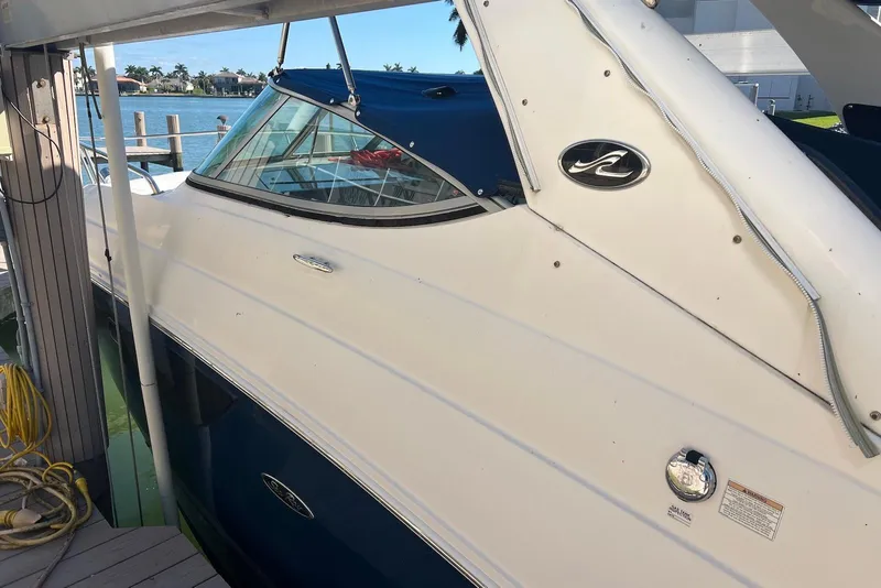 Slide: The Image of 2018 Sea Ray Sundancer 280 docked, featuring sleek white and blue design. - 7