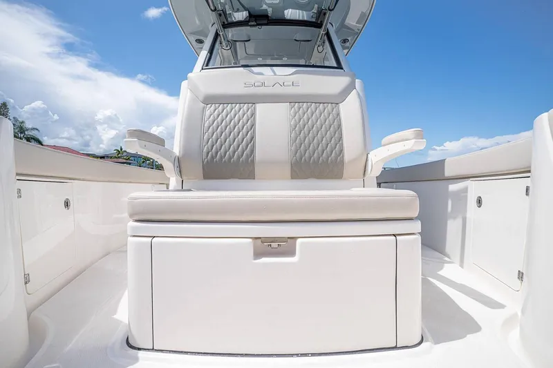 Slide: The Image of Manufacturer Provided Image: 2026 Solace 28 HCS boat interior with luxurious seating under a clear blue sky. - 10