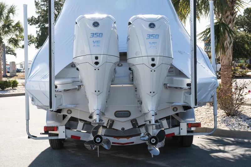 Slide: The Image of 2026 Solace 28 HCS boat with twin 350 V6 outboard engines, parked outdoors. - 2