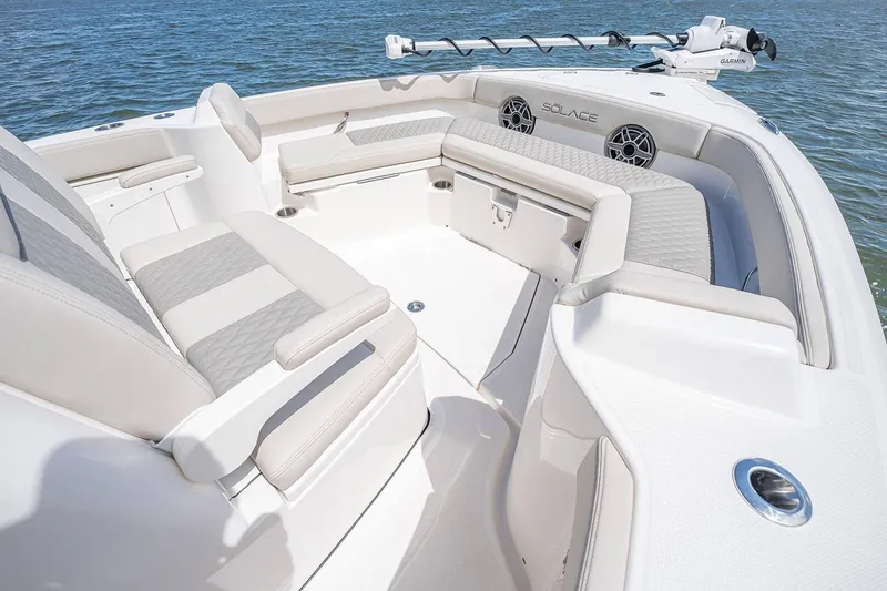 Slide: The Image of Manufacturer Provided Image: 2026 Solace 28 HCS boat interior with cushioned seating and modern design on water. - 6