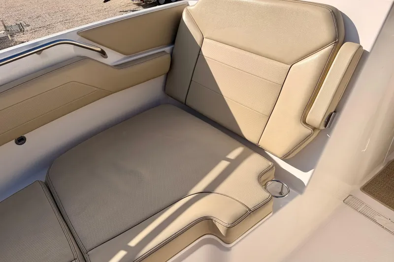 Slide: The Image of 2018 Pursuit DC 365 Dual Console boat seat, beige upholstery, sleek design. - 11