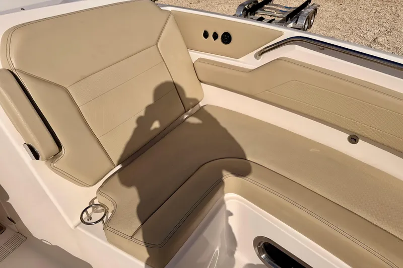 Slide: The Image of 2018 Pursuit DC 365 Dual Console boat with beige seating and sleek interior design. - 12