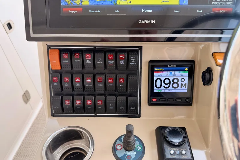 Slide: The Image of Control panel of a 2018 Pursuit DC 365 Dual Console boat with Garmin navigation system. - 17