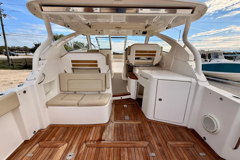 Slide: The Image of 2018 Pursuit DC 365 Dual Console boat interior with teak flooring and seating. - 28