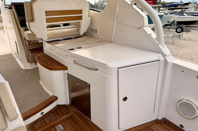 Slide: The Image of 2018 Pursuit DC 365 Dual Console boat interior with seating and storage. - 31