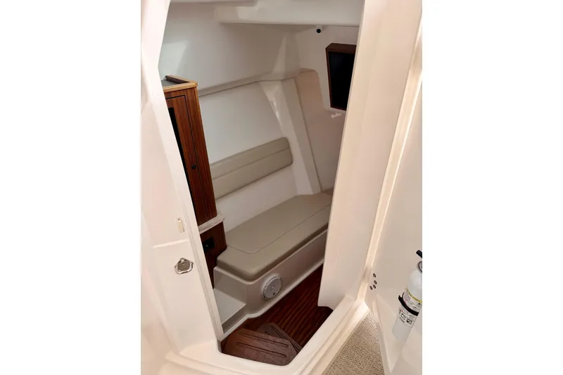 Slide: The Image of 2018 Pursuit DC 365 Dual Console cabin interior with seating and wood accents. - 36