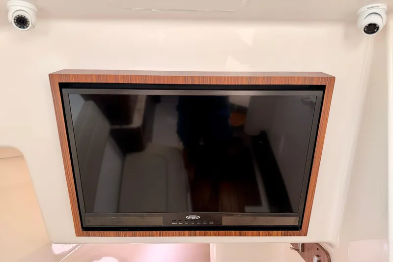 Slide: The Image of Flat-screen TV on 2018 Pursuit DC 365 Dual Console boat interior. - 39