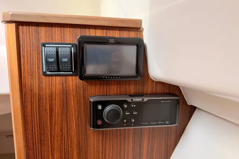 Slide: The Image of Control panel on 2018 Pursuit DC 365 Dual Console boat with wood finish and electronic displays. - 42