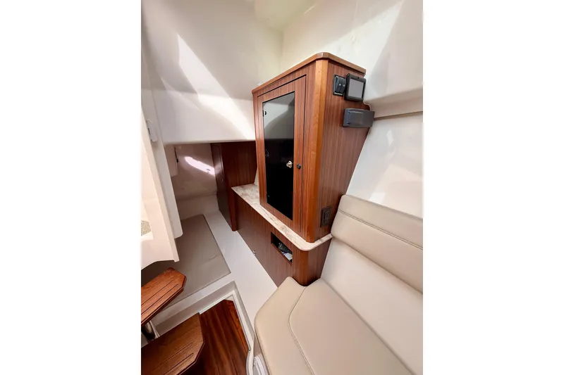 Slide: The Image of 2018 Pursuit DC 365 Dual Console interior with wood cabinetry and beige seating. - 44