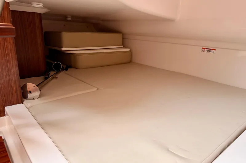 Slide: The Image of 2018 Pursuit DC 365 Dual Console cabin interior with cushioned seating and storage. - 45