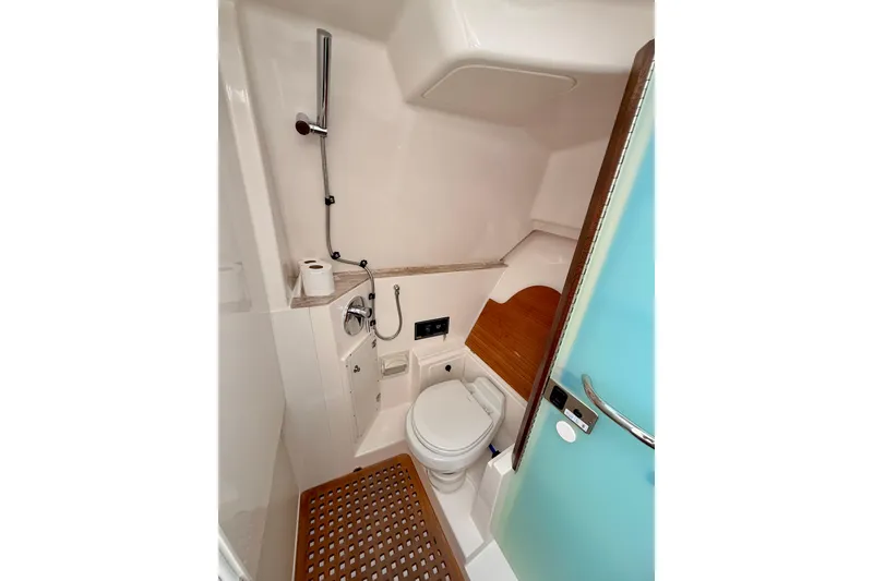 Slide: The Image of 2018 Pursuit DC 365 Dual Console boat bathroom with toilet and shower. - 48