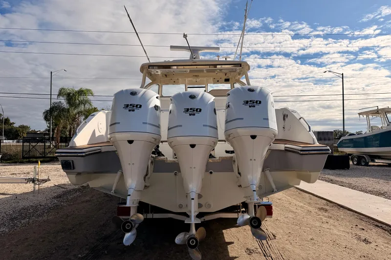 Slide: The Image of 2018 Pursuit DC 365 Dual Console with triple Yamaha 300 V8 engines, rear view. - 5