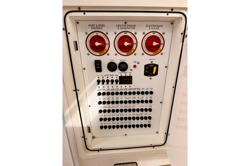Slide: The Image of Control panel of 2018 Pursuit DC 365 Dual Console boat with switches and dials. - 50