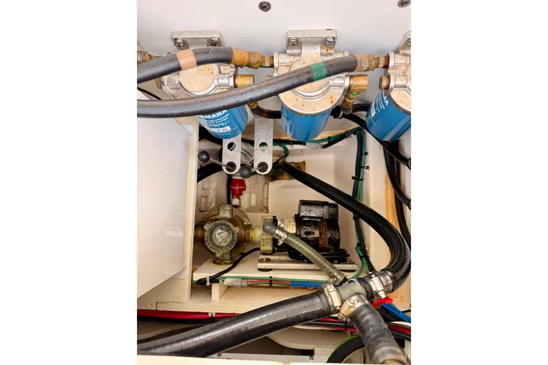 Slide: The Image of Engine compartment of 2018 Pursuit DC 365 Dual Console with visible hoses and filters. - 51