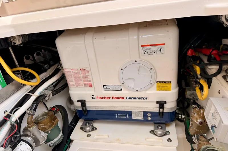 Slide: The Image of Fischer Panda generator in 2018 Pursuit DC 365 Dual Console boat engine compartment. - 54