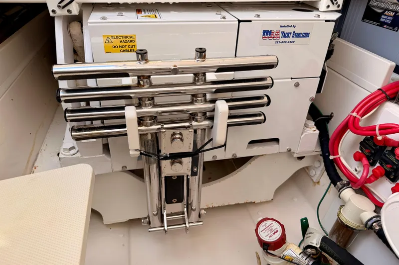 Slide: The Image of 2018 Pursuit DC 365 Dual Console boat engine compartment with electrical components and stabilizers. - 56