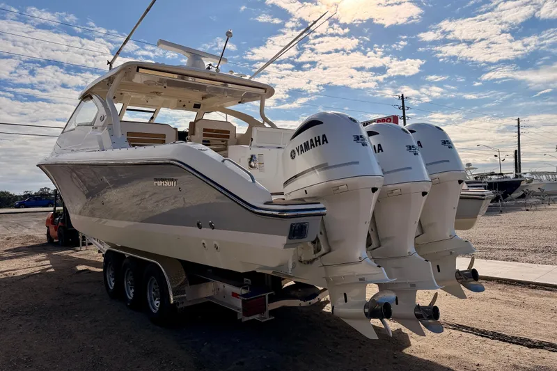 Slide: The Image of 2018 Pursuit DC 365 Dual Console boat with Yamaha engines on a trailer. - 6