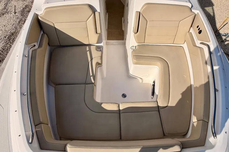Slide: The Image of 2018 Pursuit DC 365 Dual Console boat with spacious beige seating area. - 7
