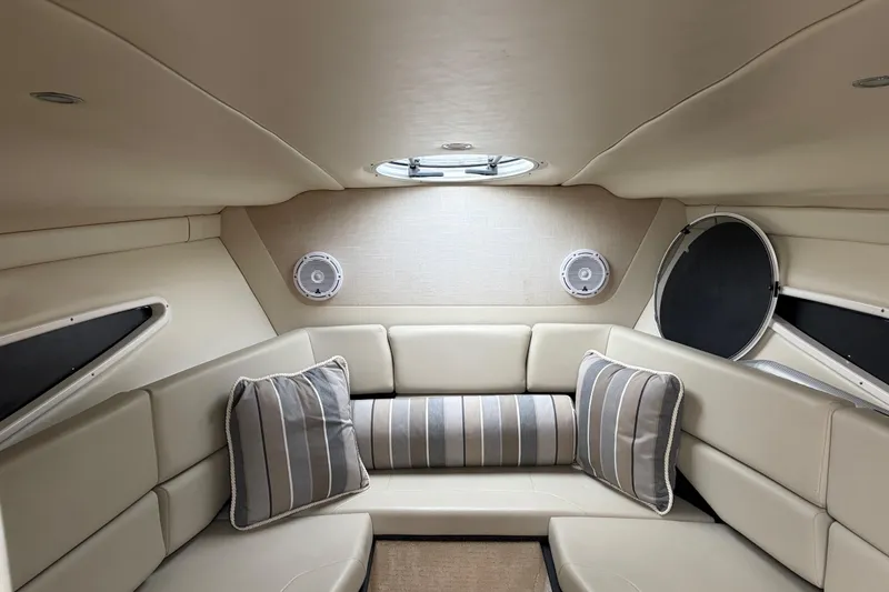 Slide: The Image of Interior of 2016 Regal 2660 Express Cruiser with beige seating and striped cushions. - 4