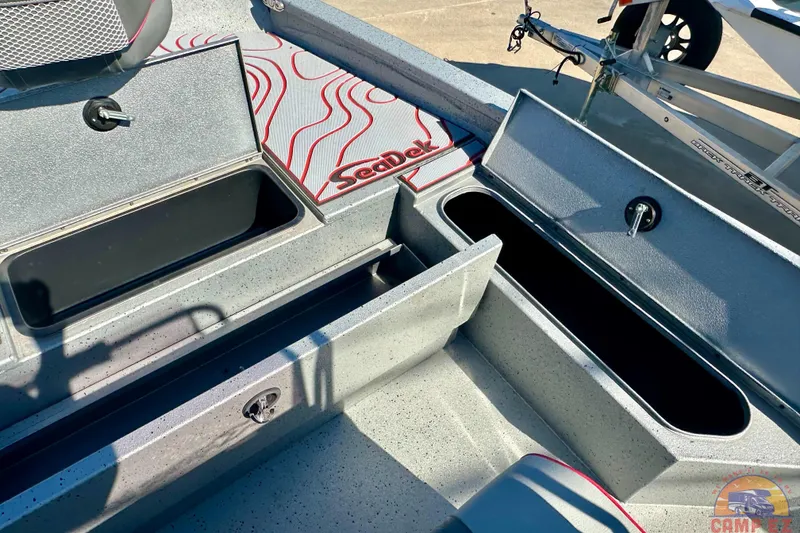 Slide: The Image of 2024 Express SW20B BAY boat storage compartments with SeaDek flooring, open for viewing. - 22