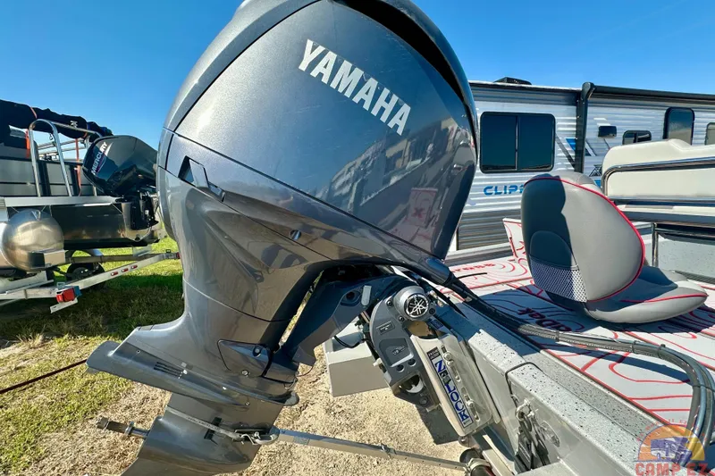 Slide: The Image of 2024 Express SW20B BAY boat with Yamaha outboard motor, parked near a camper. - 5