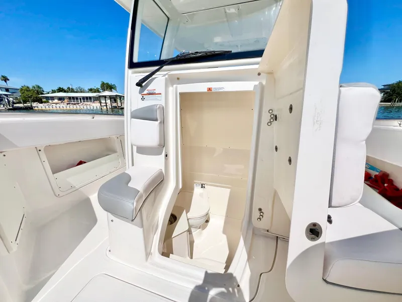 Slide: The Image of 2020 Robalo R302 Center Console boat interior with open storage compartment. - 21