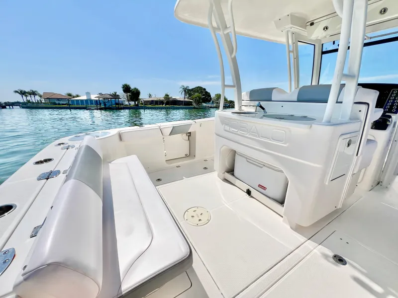 Slide: The Image of 2020 Robalo R302 Center Console boat interior with seating, on a sunny day by the water. - 8