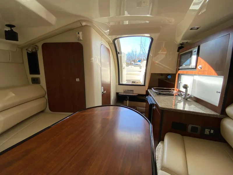 Slide: The Image of Interior of a 2014 Monterey 260 SCR yacht with kitchen and seating area. - 10