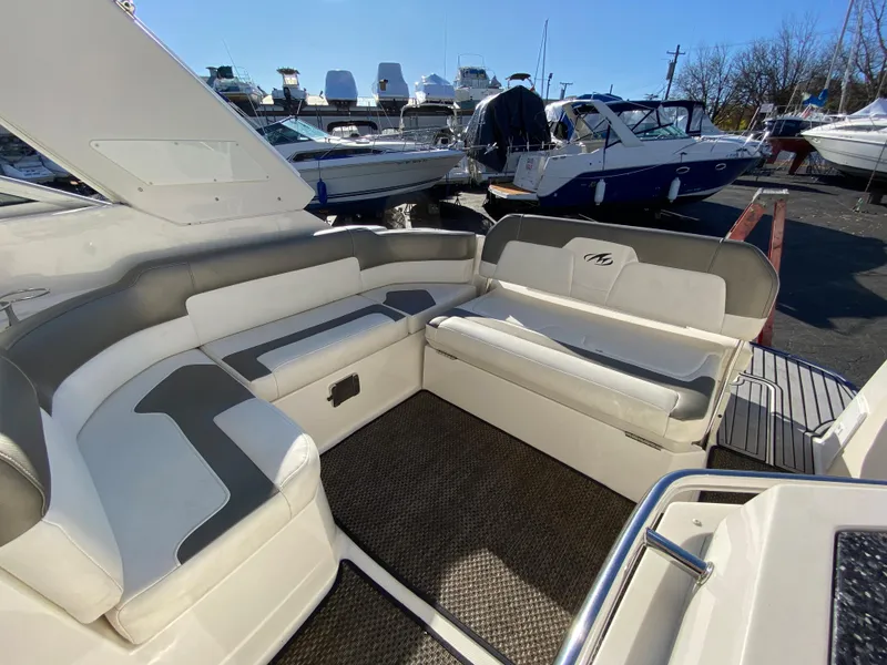 Slide: The Image of Interior of a 2014 Monterey 260 SCR boat with white seating. - 2