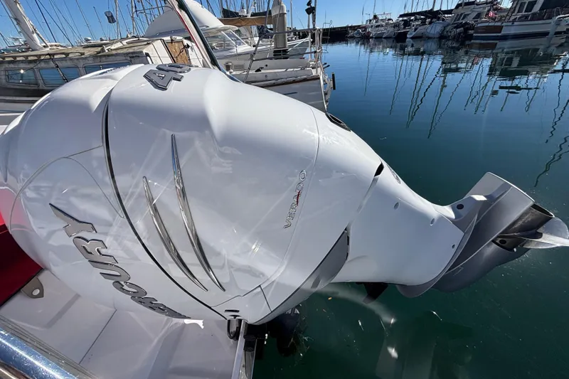 Slide: The Image of Outboard motor on 2022 Axopar 28 AFT CABIN boat, docked in marina. - 13