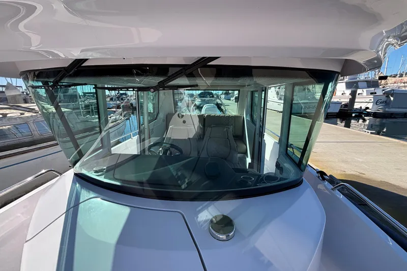 Slide: The Image of 2022 Axopar 28 AFT CABIN boat, docked, showcasing sleek design and spacious cabin. - 15